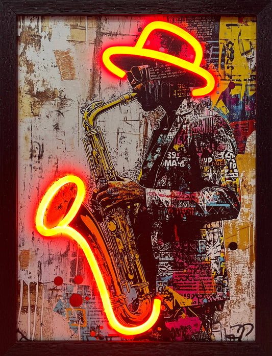 Framed mixed media pop art featuring a silhouette of a musician in sunglasses playing a saxophone, set against a distressed graffiti background. A vibrant, functional yellow LED neon light outlines his fedora and the bell of the sax, adding a distinct glow to this unique jazz-inspired wall decor.